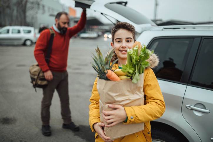 Boy and his father after grocery shopping