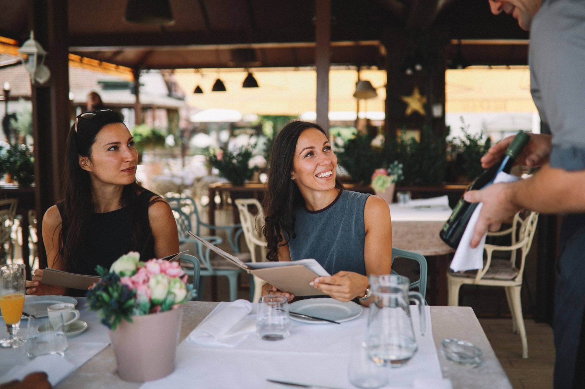 Female friends ordering food in the restaurant Female friends ordering food in the restaurant