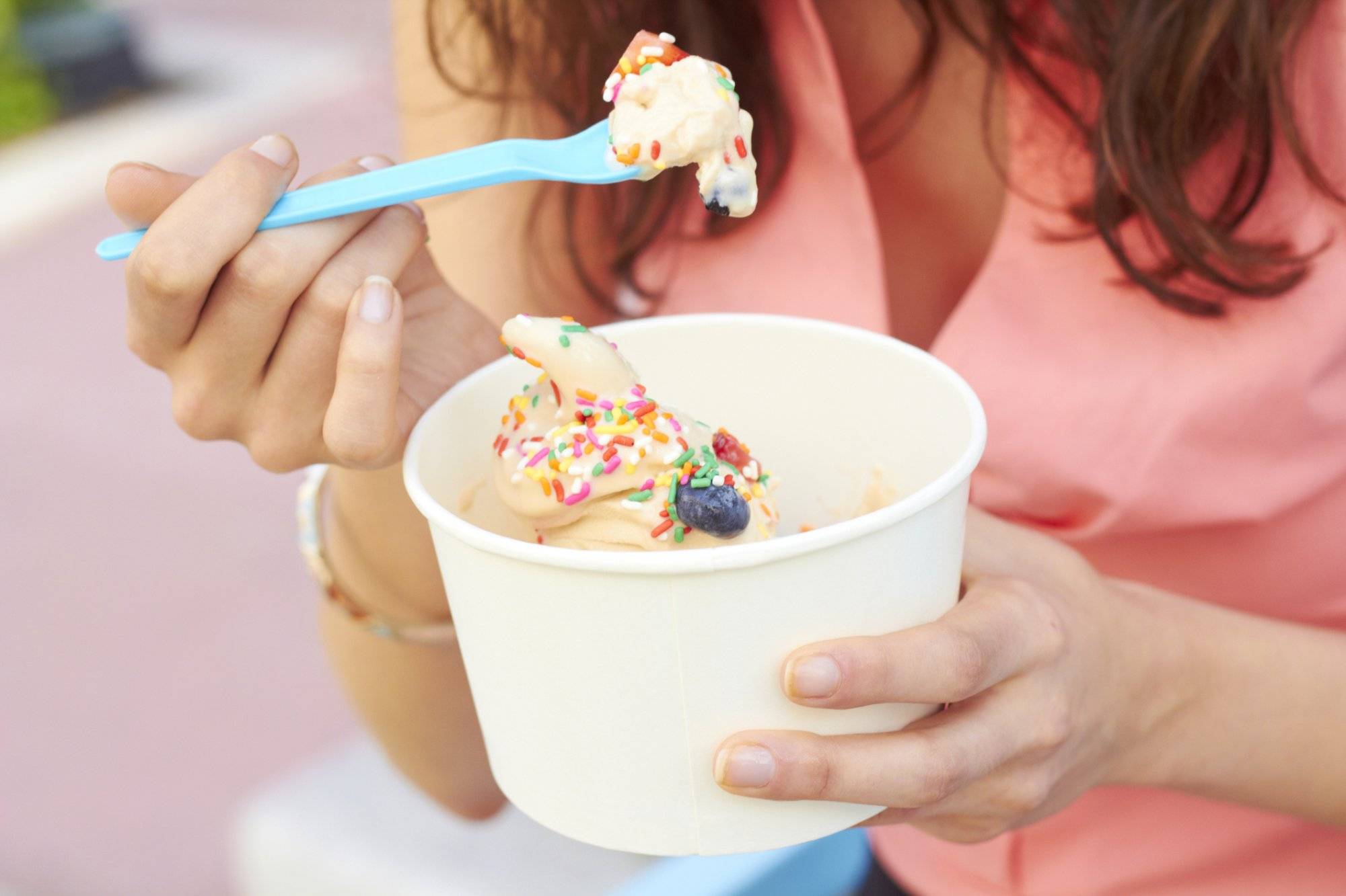 Woman Eating Frozen Yogurt With Berries Woman Eating Frozen Yogurt With Berries