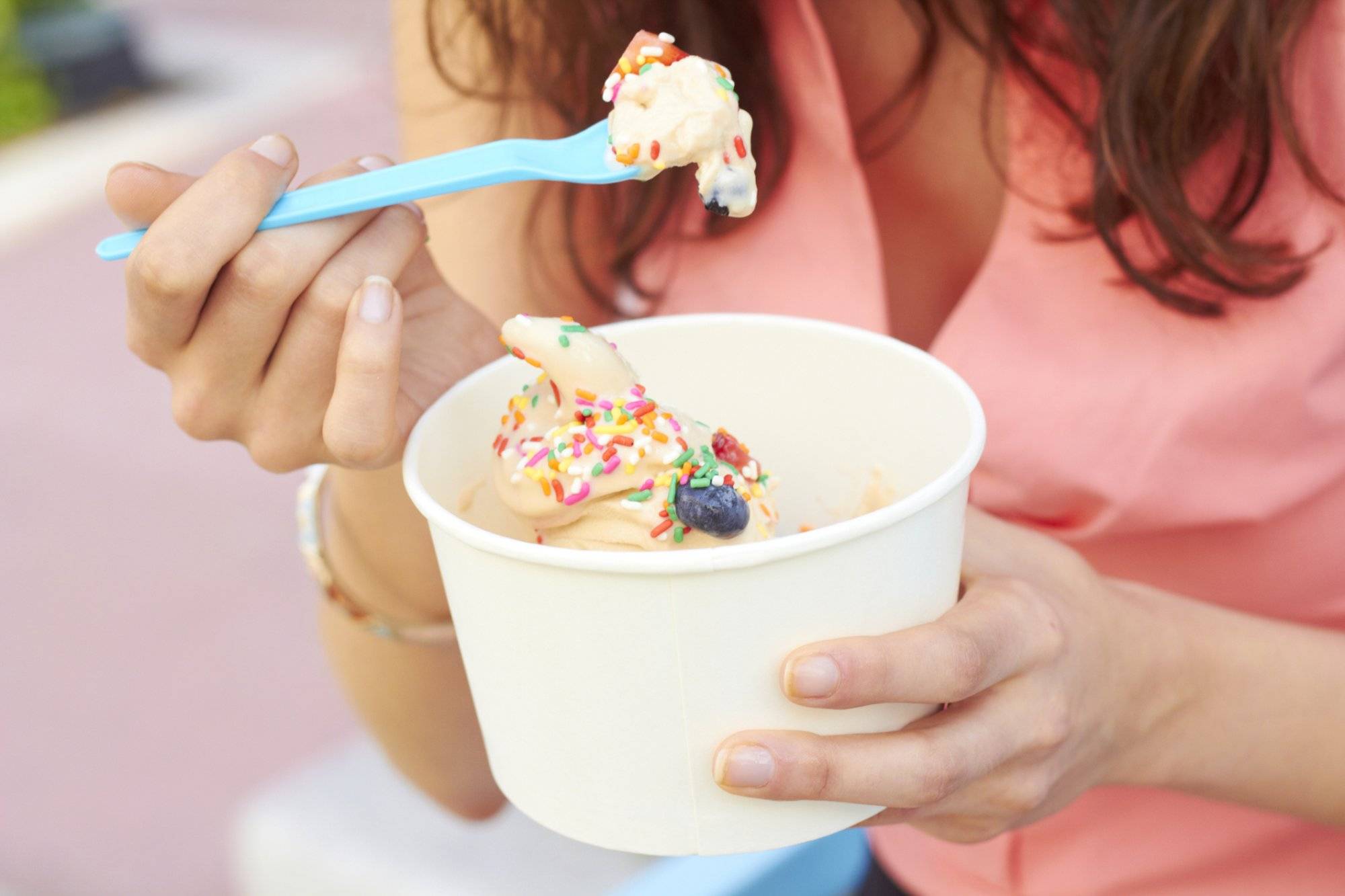 Woman Eating Frozen Yogurt With Berries